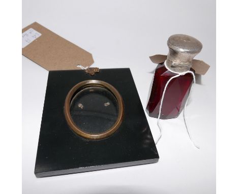 An early 20th Century silver topped ruby glass scent bottle, together with an Edwardian ebonised photo frame (2) 
