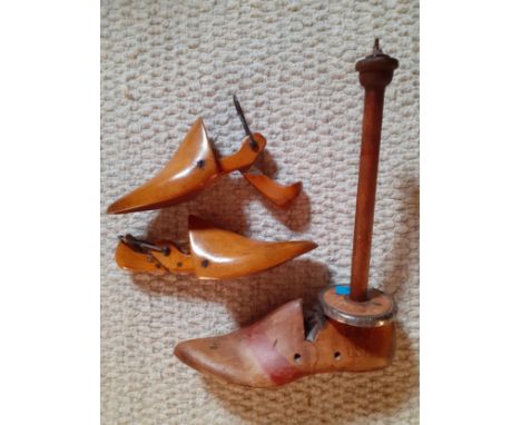 A pair of vintage wooden shoe stays together with a single American boot stay on pole with makers initials JV, size 4D and a 