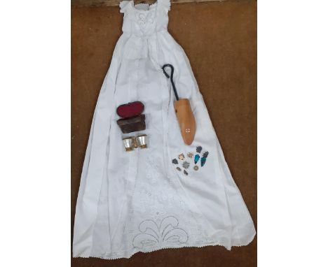 An early 20th century white cotton Christening gown, a single treen shoe stay, mother of pearl opera glasses, Chinese earring