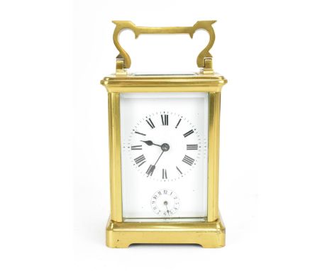 A French brass and bevelled glass cased alarm clock, with white enamel face with Roman numerals, above an Arabic numeral alar