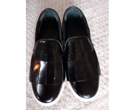 Celine-A pair of 'Kiltie' black glazed leather brogue style casual slip-on shoes with white rubber soles and fringe detail, E