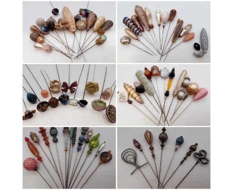 A collection of Victorian, Edwardian and later vintage hat pins mounted on later decorative doll bonnets to include Continent
