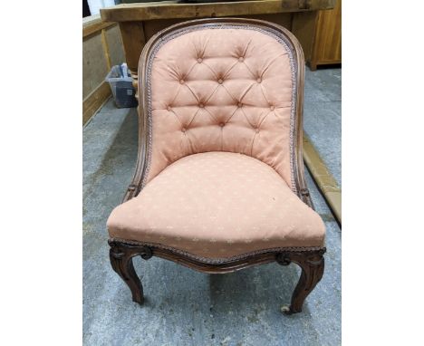 A Victorian mahogany framed button back upholstered nursing chair, carved French carbide legs on porcelain casters along with