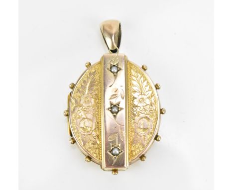 A Victorian yellow metal and pearl inset locket, of oval form with central band set with pearls in star cut, against an engra
