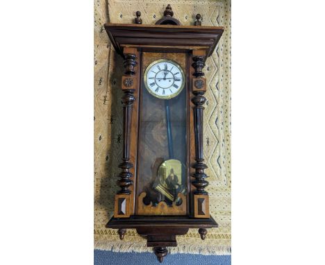 A Vienna style wall hanging clock having unsigned enamel dial with Roman numerals, with pendulum and weightsLocation: 