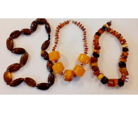 Three vintage amber bead necklaces to include rough-cut beads. Location:BWR 
