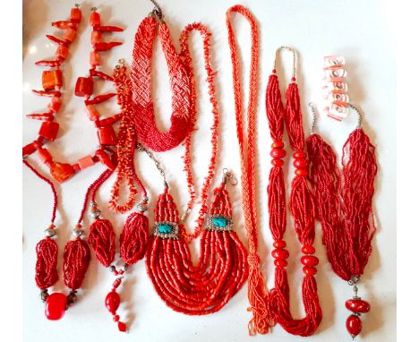 A quantity of vintage red coral costume jewellery to include tribal multi-strand examples and necklaces with additional resin