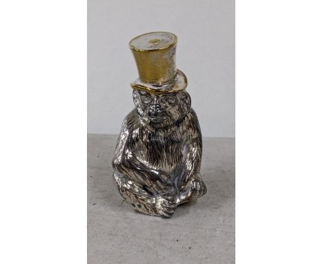 A German cast metal table light modelled as a seated monkey with a top hat, marked Wurttemberg to the base, 7cm hLocation: 