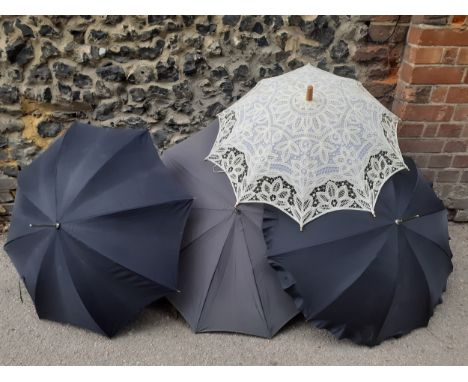 Four vintage umbrellas and parasols to include a Parisian black umbrella with cream lace under layer and silver tone handle a