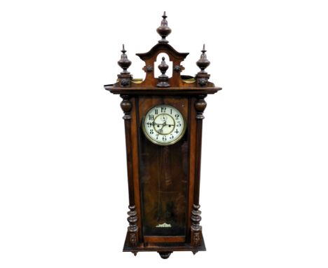 A late 19thC mahogany cased Vienna wall clock, circular brass dial with enamel chapter ring bearing Arabic numerals, subsidia