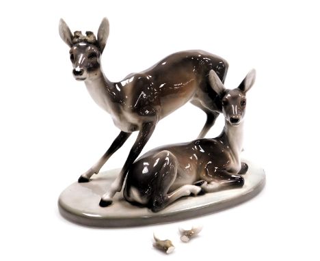 A Goldscheider Art Deco figure of two deer, model number 4760/49/6, artist initial F, 29cm high, 37cm wide. (antlers missing)