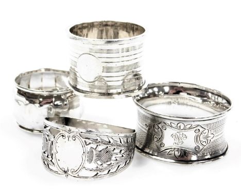 A George V silver napkin ring, with engine turned decoration, Birmingham 1930, two further silver napkin rings, and a French 