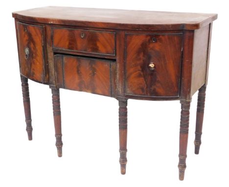A George III mahogany bowfront sideboard, with cellaret drawer, central frieze drawer and concealed drawer, with ebonised rin