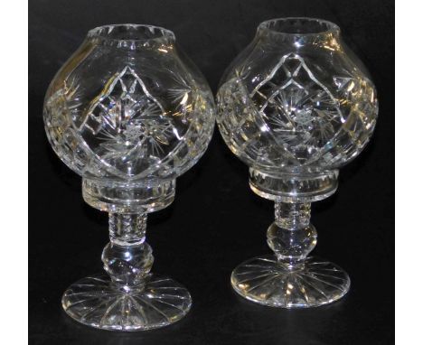 A pair of late 20thC cut glass storm lamp type candle holders, 26cm high.