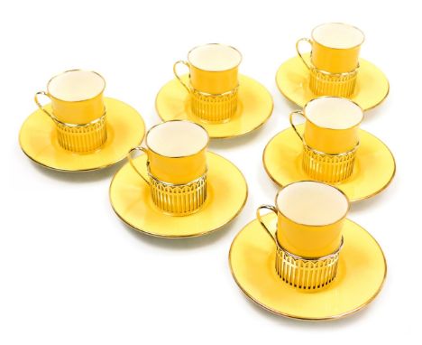 A set of six early 20thC Wedgewood porcelain demi-tasse coffee cans and saucers, canary yellow ground, the cups with silver h