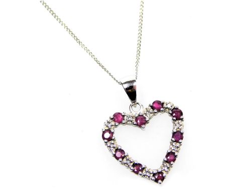 A 9ct white gold ruby and diamond heart shaped pendant, on a ring suspension, and fine curb link neck chain, 2.1g.