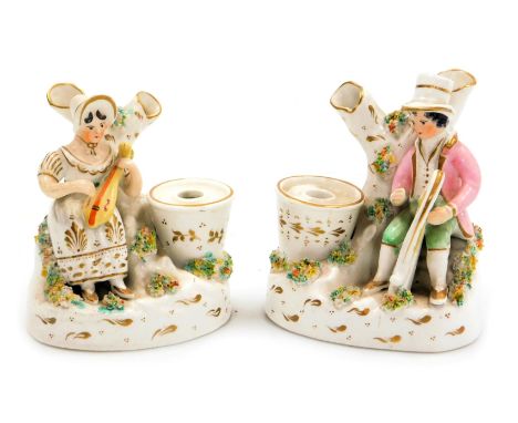 A pair of late 19thC Staffordshire pottery inkwells, modelled with a seated man playing a harp, a lady playing a lute, seated