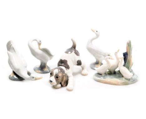 A LLadro porcelain figure of a spaniel puppy, together with Lladro and Nao porcelain figures of geese, and a group of ducks. 