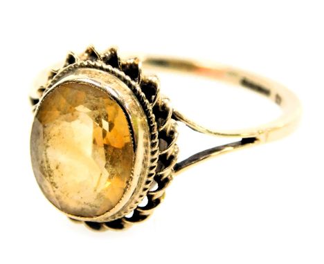 A 9ct gold and citrine ring, oval cut, in a high claw setting size O, 2.3g.