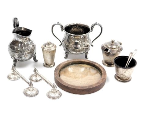 A George V silver three piece condiment set, of Art Deco design, London 1934, a pair of knife rests, cream jug and sugar basi