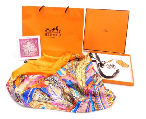 A Hermes orange silk scarf, decorated with a bejewelled and feather strewn head dress, boxed, 128cm x 126cm.