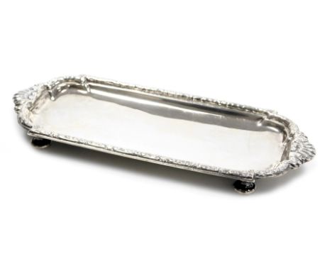 A George V Britannia silver wick trimmers or pen tray, of cast shaped rectangular form with shell handles, on low button feet