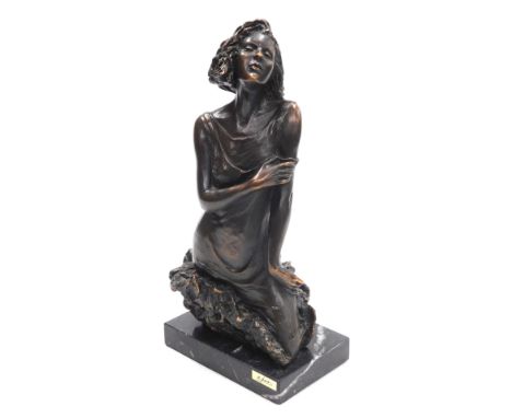 A late 20thC Andre Paor bronze sculpture of a young woman, modelled emerging from a rock raised on a rectangular marble base,