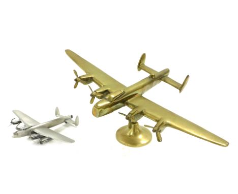 A brass desk stand, modelled as a WWII Avro Lancaster, raised on a circular base, 35.5cm wide, together with a pewter model o