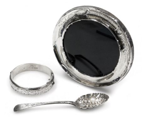 A George III silver berry spoon, the bowl embossed with a leaf and berries, with an engraved handle together with a silver ba