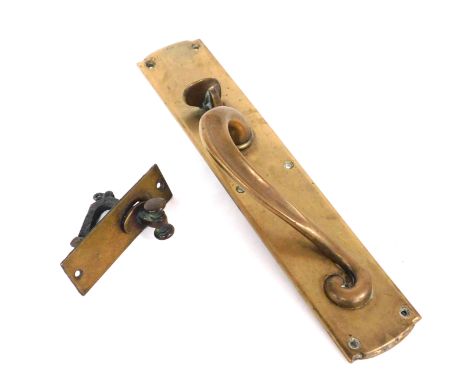A Victorian art nouveau brass shop door handle, with latch, 34.5cm high, together with a brass door knocker, 12cm high. (2)