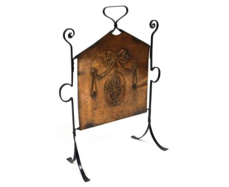 A late Victorian cast iron and copper firescreen, embossed in the Adam style with an oval medallion and tied bow, raised on a