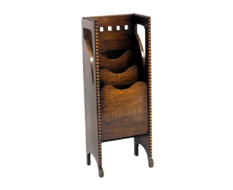 An early 20thC oak newspaper and magazine rack, of waterfall form, 97cm high, 37cm wide, 24.5cm deep.