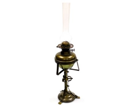 An early 20thC Jugenstil style brass oil lamp, presentation engraved, with a glass chimney, 71cm high.