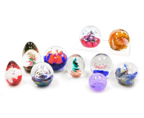 A group of glass paperweights, including a Caithness Moon Crystal weight, a Myriad weight and a Selkirk Emerald Dance paperwe
