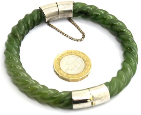 Jade Oriental bangle, with safety chain. D: 8 cm, 45g. P&amp;P Group 1 (£14+VAT for the first lot and £1+VAT for subsequent l