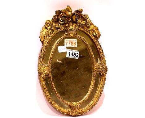 An oval gesso gilt framed wall mirror, overall 34 x 22 cm. Condition report: Gilt loss of around top of mirror, No visible da