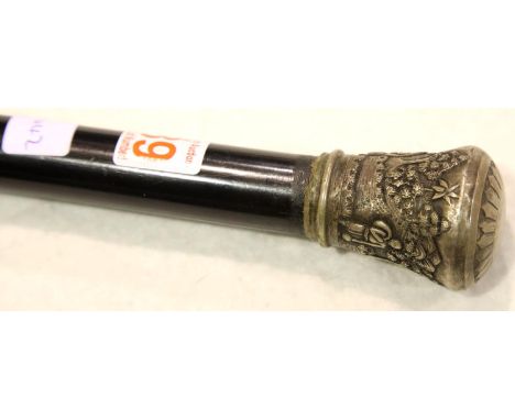 A 19th century ebonised walking cane having a large Indian silver pommel, decorated with figures, foliage and buildings, L: 9