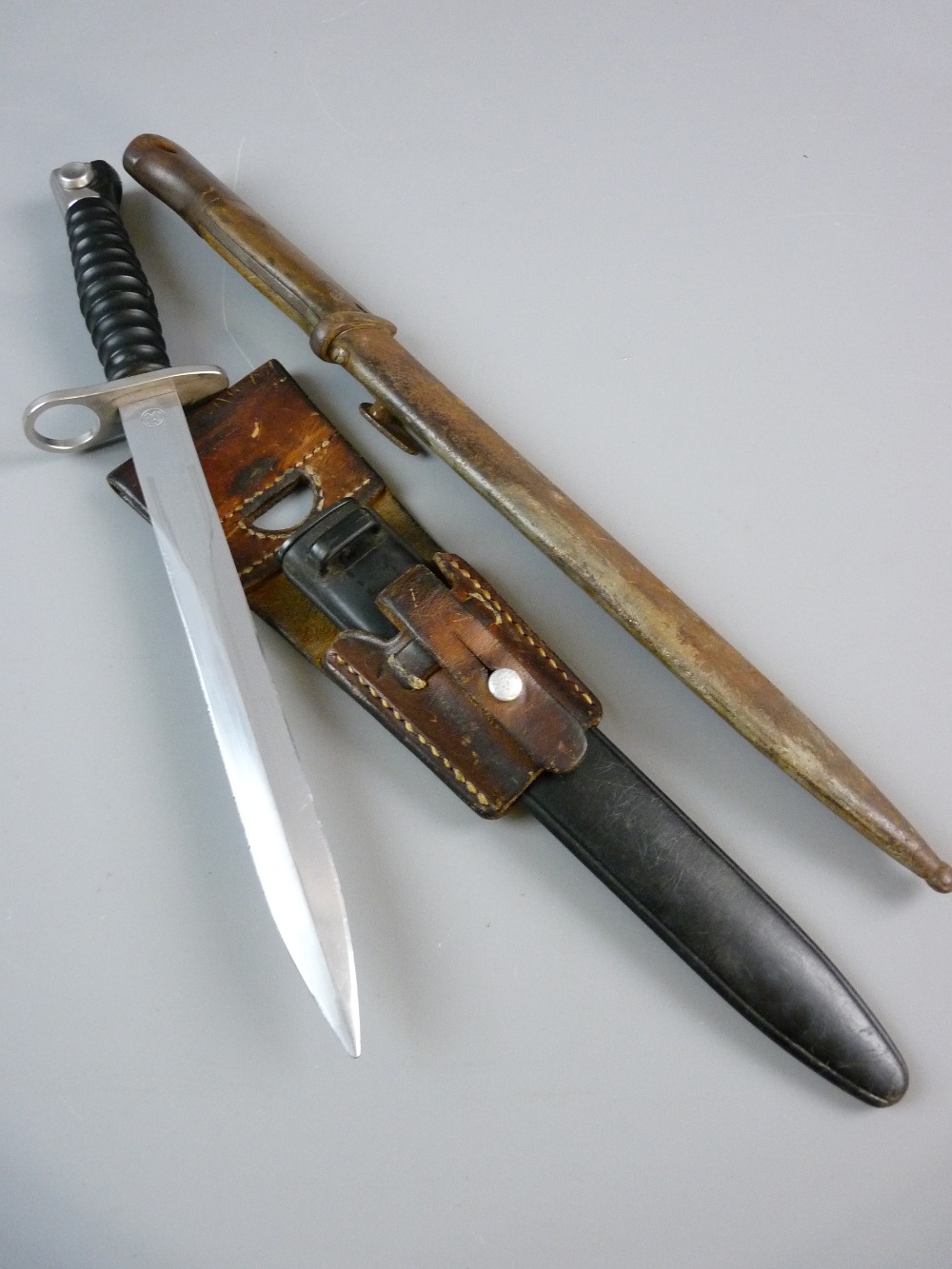 A MODERN STG 57 SWISS BAYONET with scabbard and frog, manufactured by ...