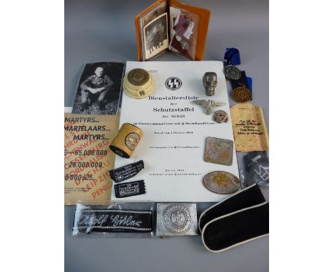 A COLLECTION OF GERMAN SS MEMORABILIA to include an office desk weight, an officer's cap eagle and cap death's head, a packet