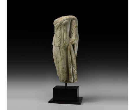 2nd-3rd century AD. A carved marble goddess or noble lady, standing with palla draped over the left shoulder and arm; the fol