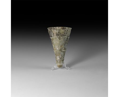 5th-8th century AD. A conical iridescent glass lamp with circumferential ribbing, slightly everted rim.   92.3 grams, 13cm (5