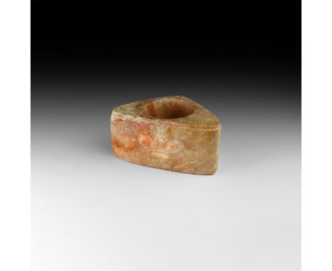 Neolithic period, circa 3000-2000 BC, or later. A carved ritual cong of rounded triangular form with central waisted vertical