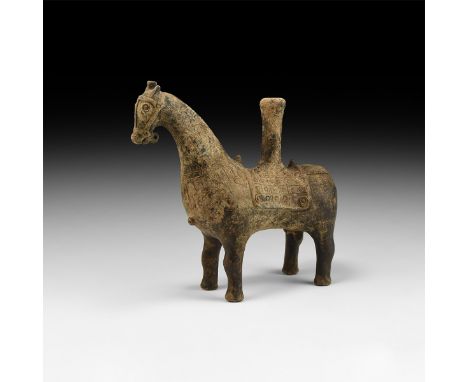 1st millennium BC. A ceramic vessel formed as a horse with arched neck, saddlecloth, crupper with impressed pendants to the r