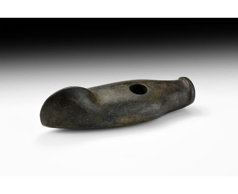 Late 3rd-early 2nd millennium BC. A large and finely polished boat-shaped axe in dark greenstone, with expanded asymmetric co