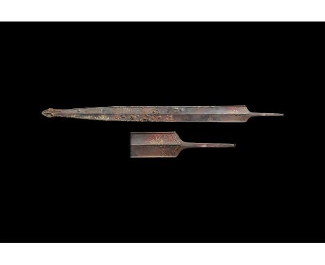 1st century BC-1st century AD. An iron sword within its iron scabbard with fittings; the sword of standard La Tène type, two-