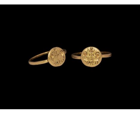 6th-8th century AD. A gold round section hoop with attached round bezel; the bezel engraved with three nimbate saints around 