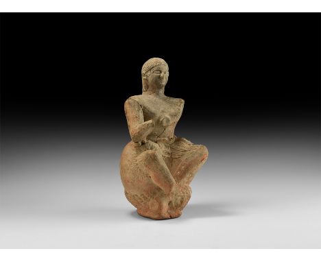 5th-3rd century BC. A hollow-formed ceramic figure of a satyr with human head and torso, horse's legs and tail, seated on a w