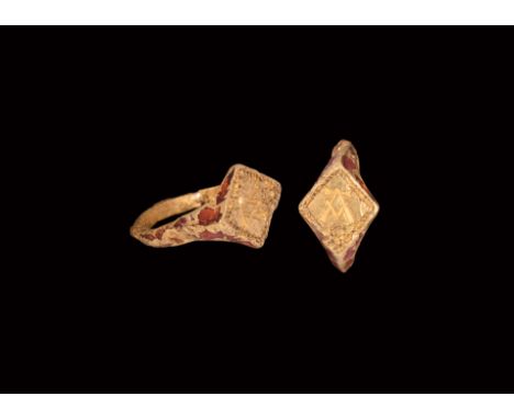 13th-14th century AD. A gold ring comprising a cusped D-section hoop, flared shoulders and lozengiform plaque, band of enamel