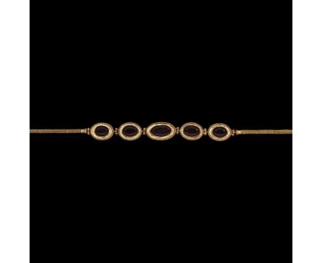 1st century BC-1st century AD. A fine round-section trichinopoly band with loop and collar to each end, series of five gradua