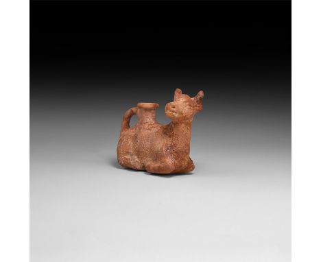 17th-19th century AD or earlier. A ceramic vessel in the shape of a reclining bull with erect pierced head, the body decorate